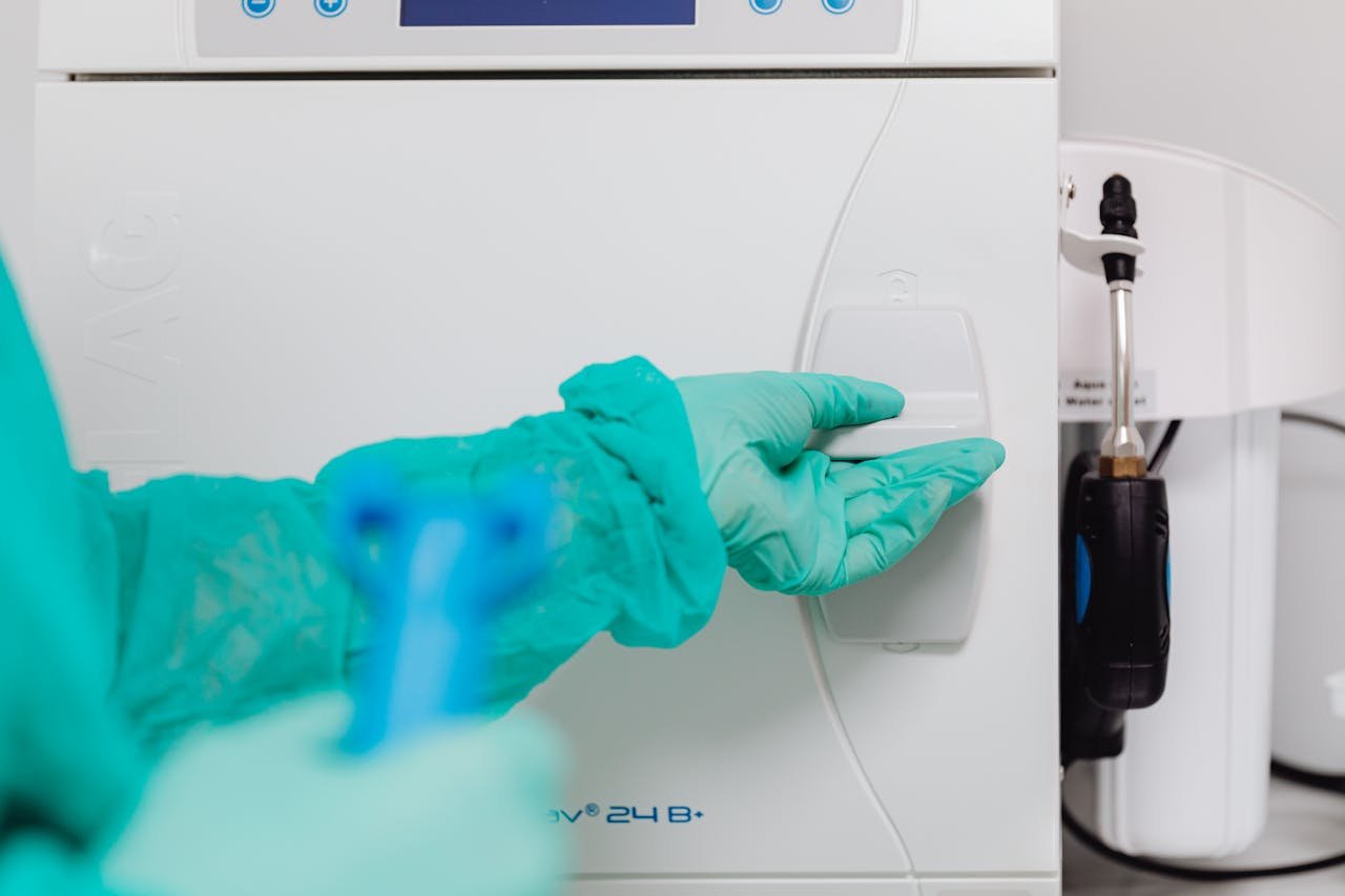 A Dentist Using an Autoclave Machine